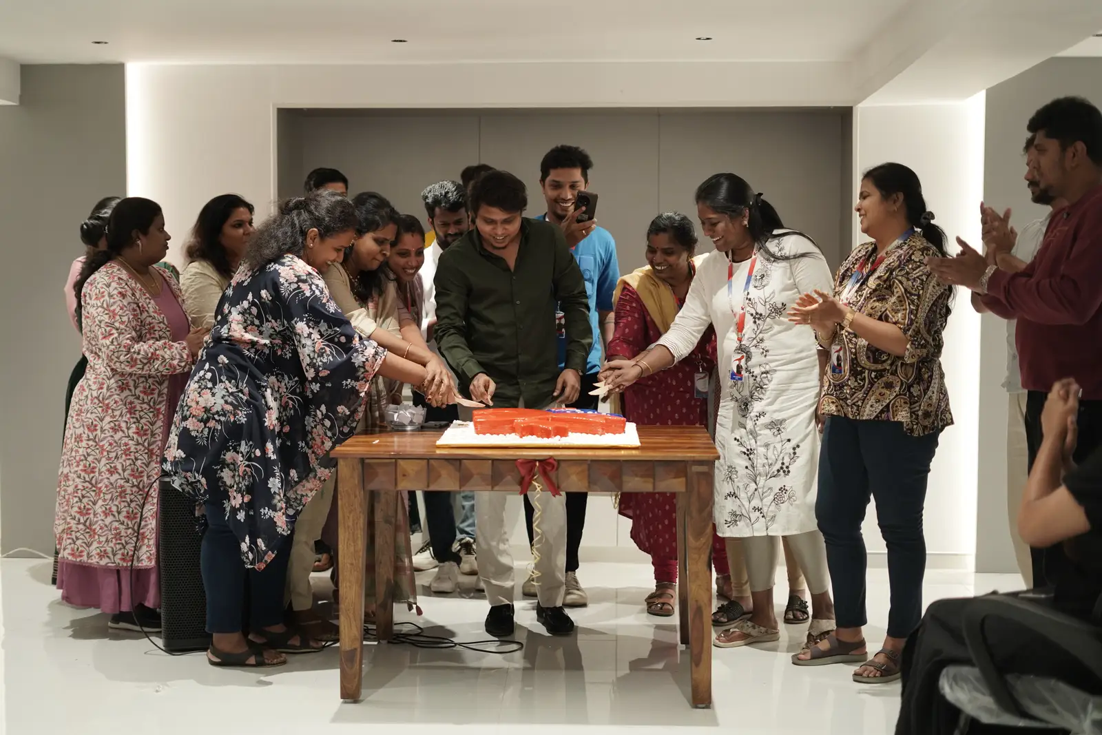 The Croyez team cutting the anniversary cake together